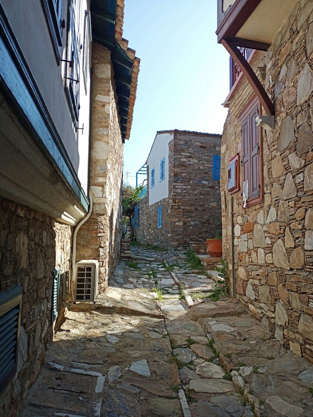 a narrow cobblestone street in a small village