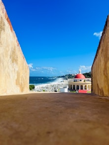 a view of the ocean from an alley way