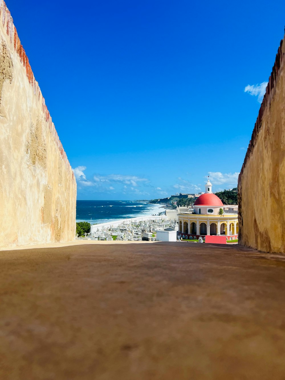 a view of the ocean from an alley way