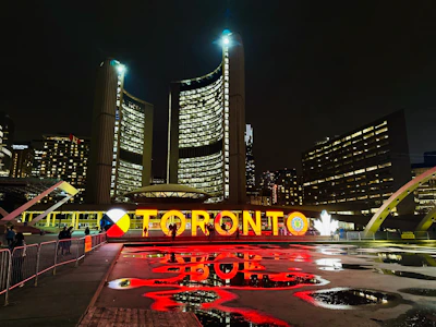 A sleek office wall adorned with a large acrylic Toronto cityscape print glowing under soft lighting.