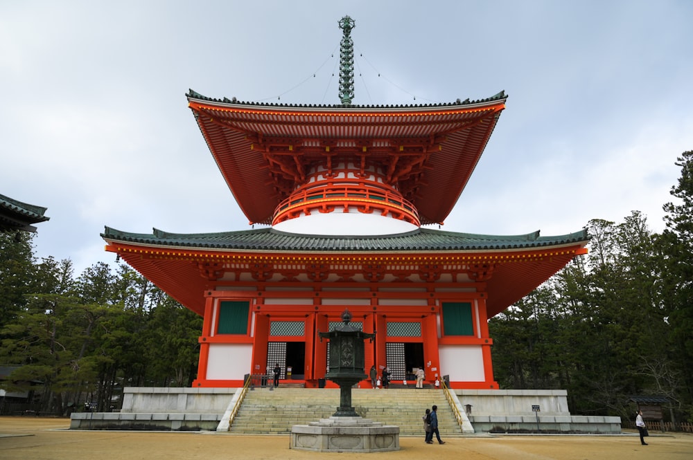 a tall red building with a green roof