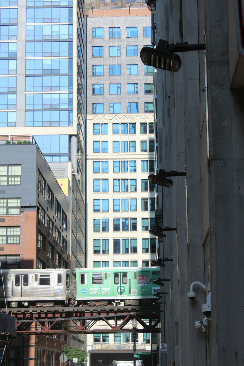 a train traveling through a city next to tall buildings