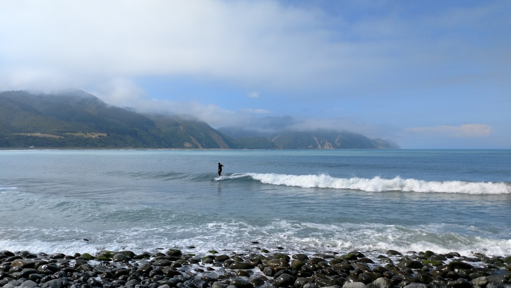 une personne surfant sur une vague sur une planche de surf