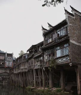 Traditional wooden house on stilts by a river in Cambodian countryside