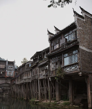 Traditional wooden house on stilts by a river in Cambodian countryside