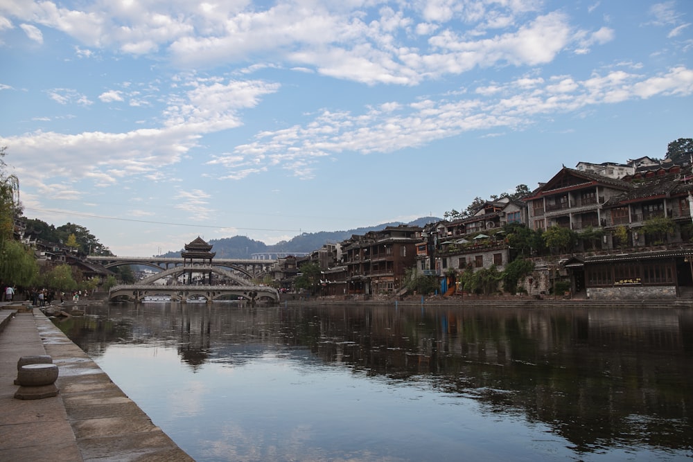 a body of water with a bridge in the background