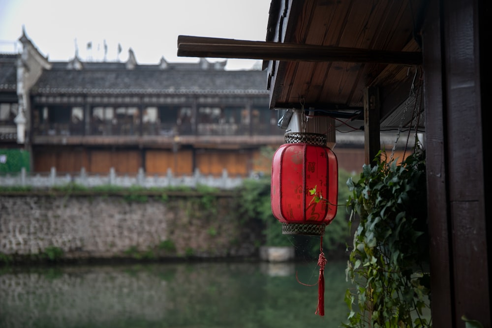 a red lantern hanging from the side of a building