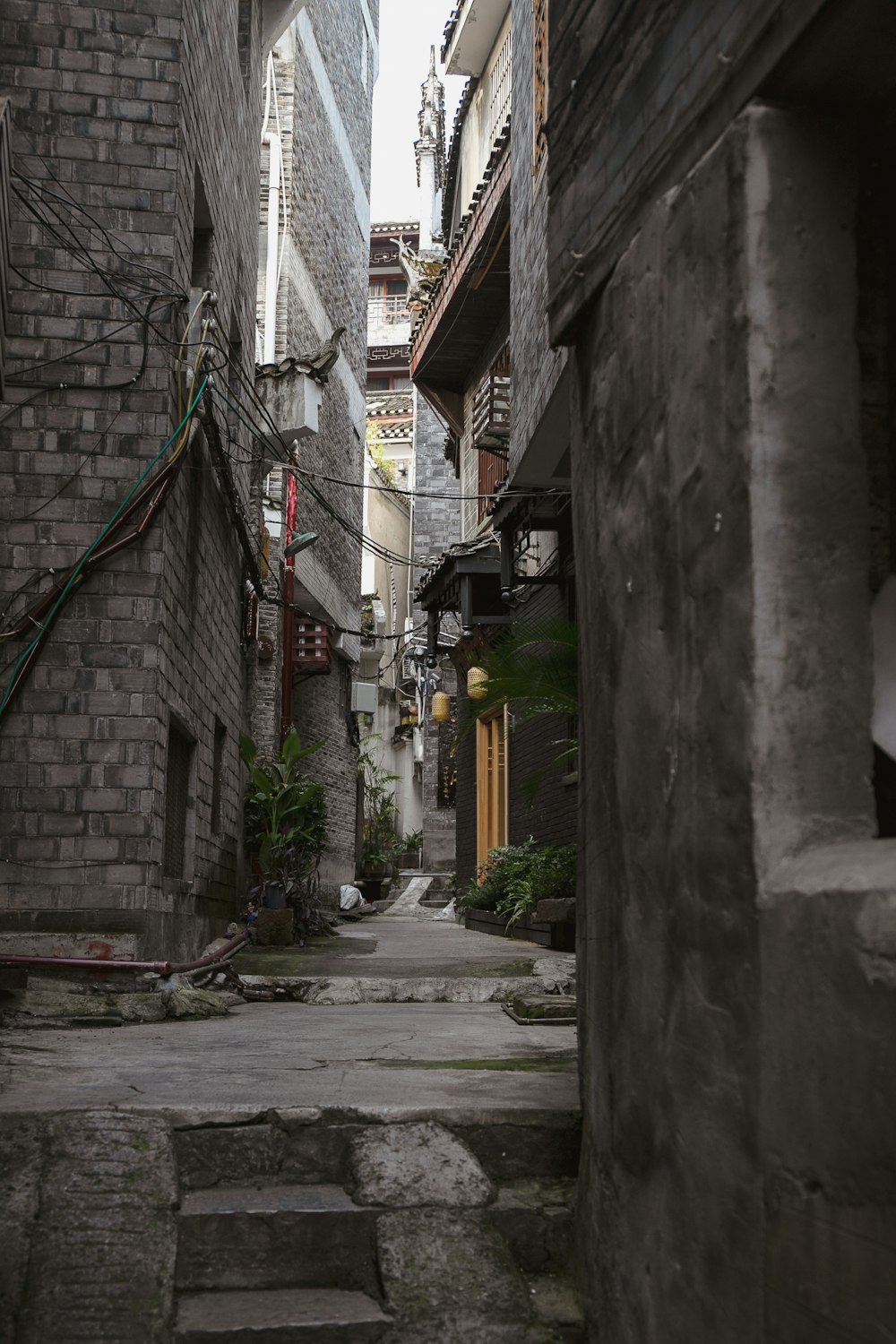 a narrow alleyway with steps leading to buildings