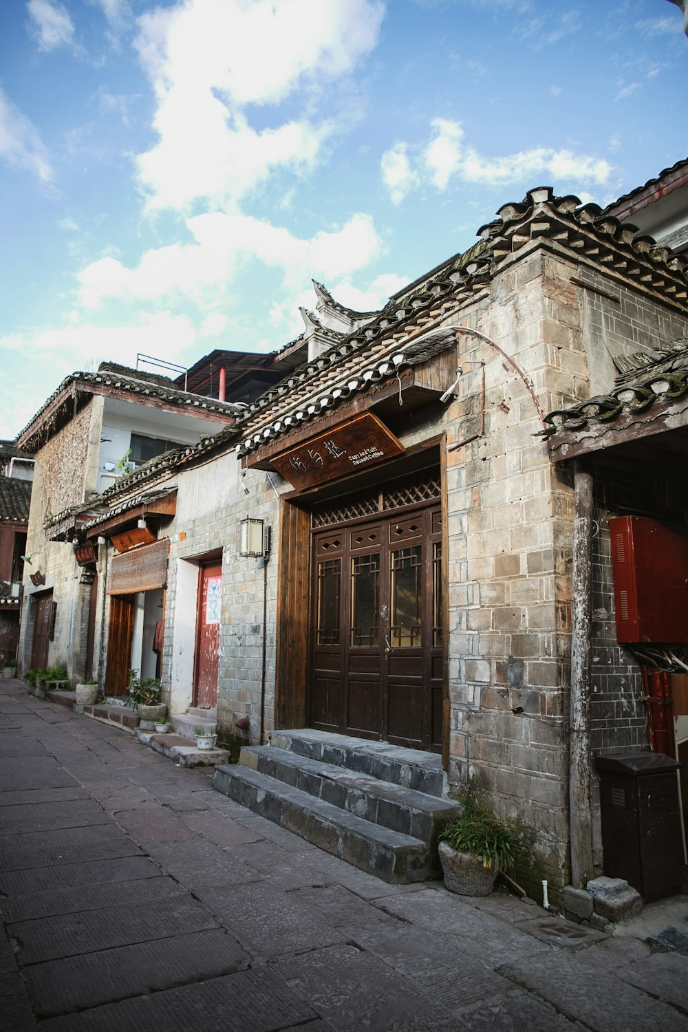 a stone building with a wooden door and steps