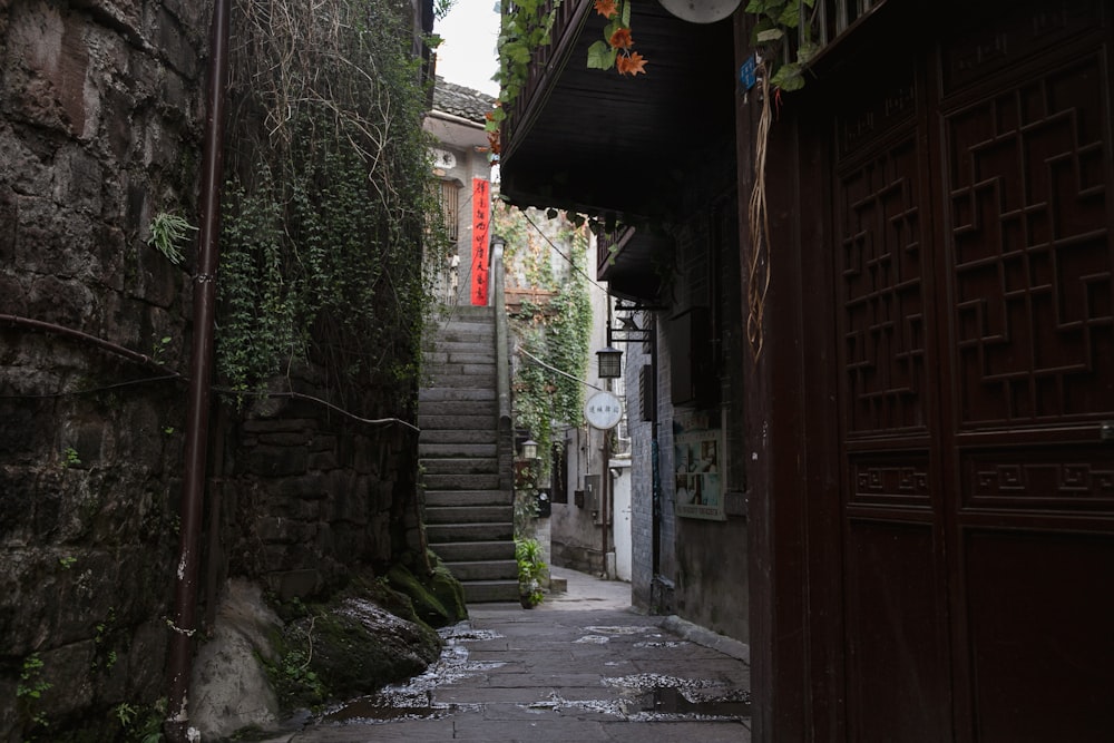 a narrow alley way with a clock on the wall