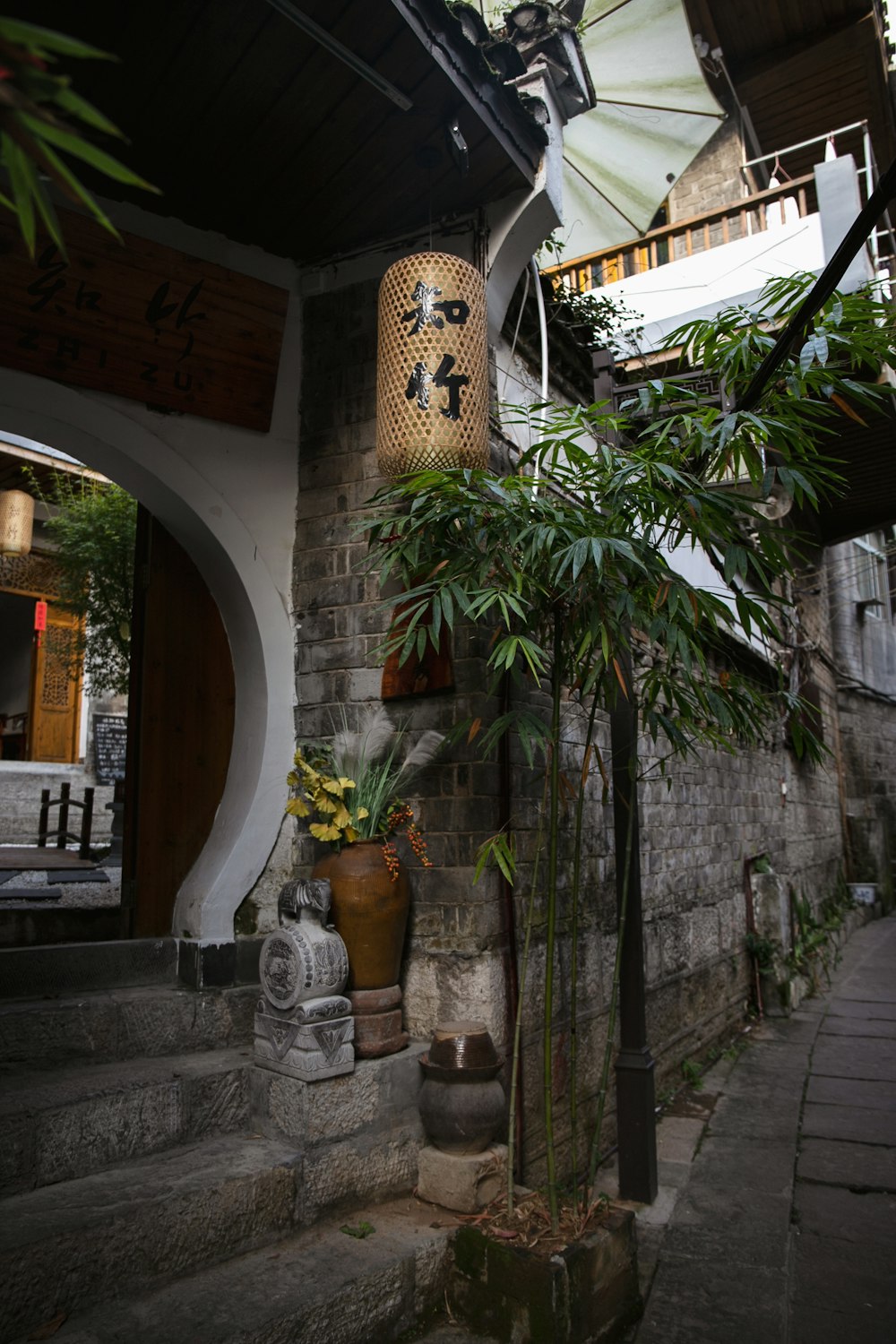 a stone building with a plant in a pot next to it