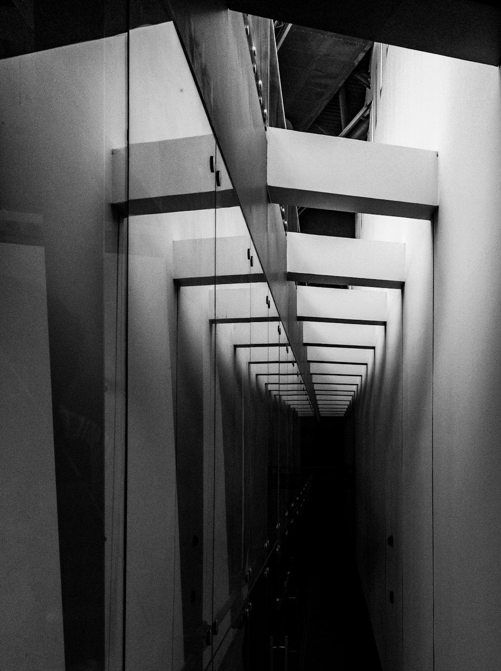 a black and white photo of a long hallway