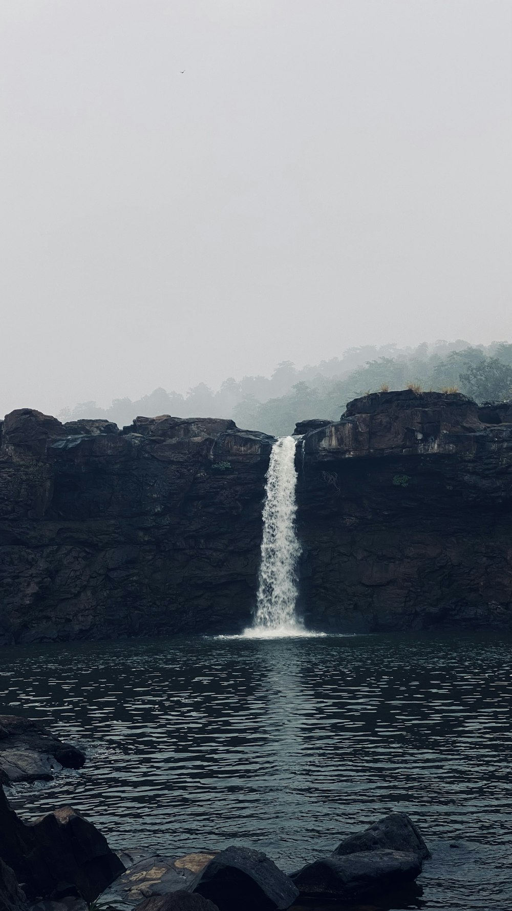 a large waterfall is coming out of a body of water