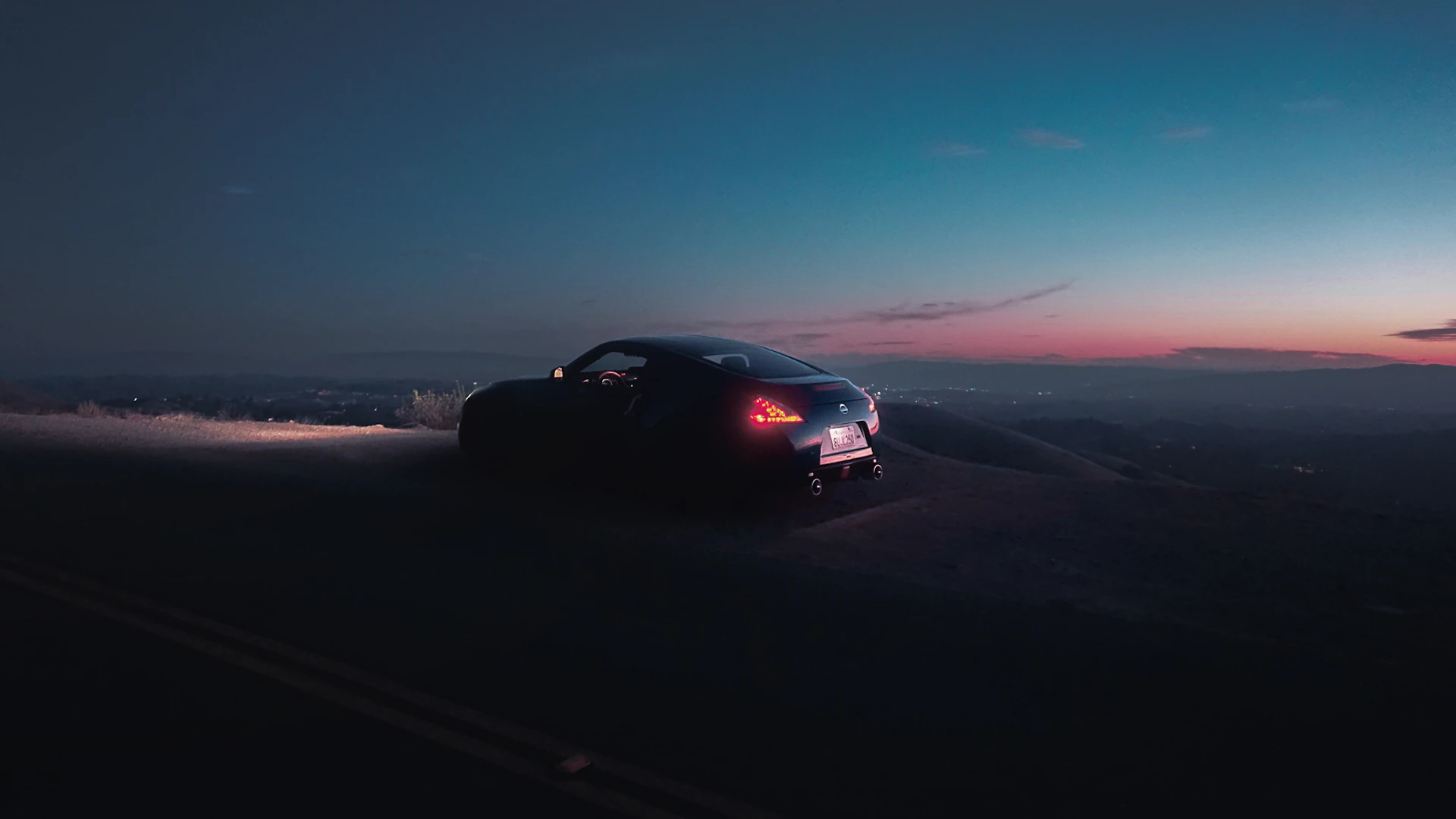 a car driving down a road at night