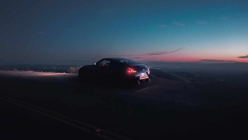 a car driving down a road at night