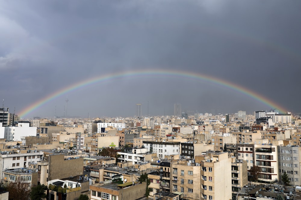 a rainbow in the sky over a city