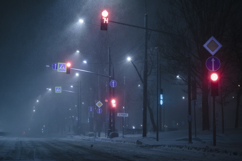 a city street at night covered in snow