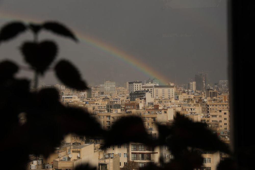 a view of a city with a rainbow in the sky