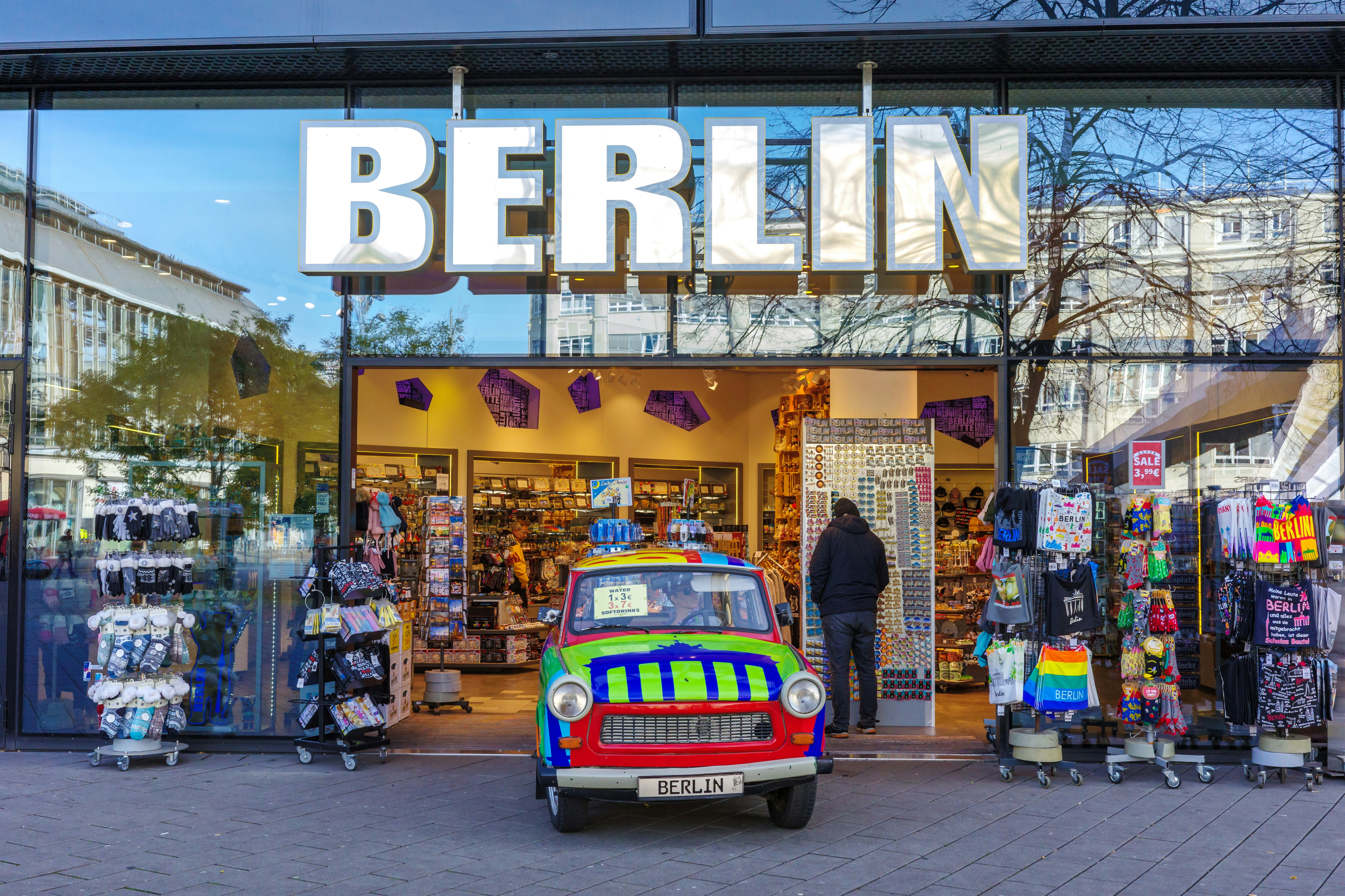 a small car parked in front of a store