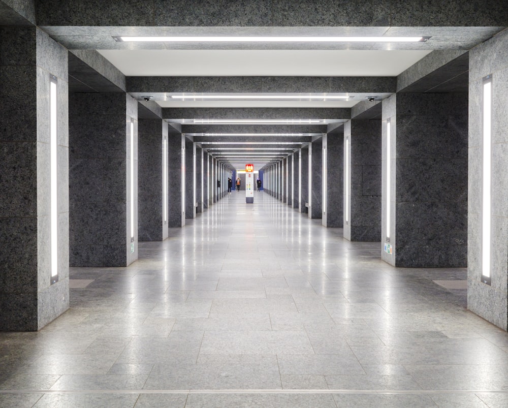 a long hallway with lights on either side of it