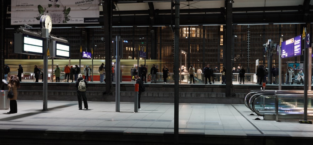 a group of people standing outside of a building at night