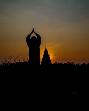 A serene group meditation under a glowing sunset, symbolizing collective harmony.