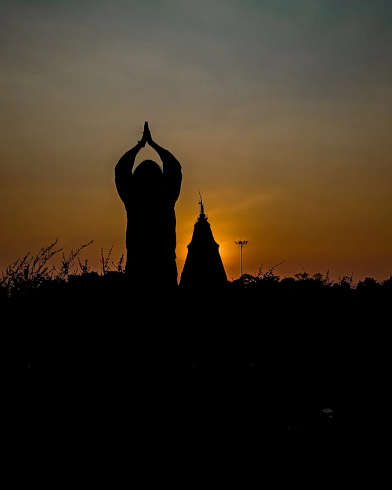 A serene and peaceful image of a person meditating outdoors at sunset, symbolizing emotional and spiritual calm.