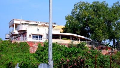 Spacious 10 marla double-storey house with balcony overlooking greenery.