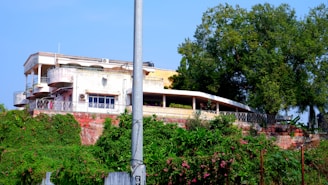 Spacious 10 marla double-storey house with balcony overlooking greenery.