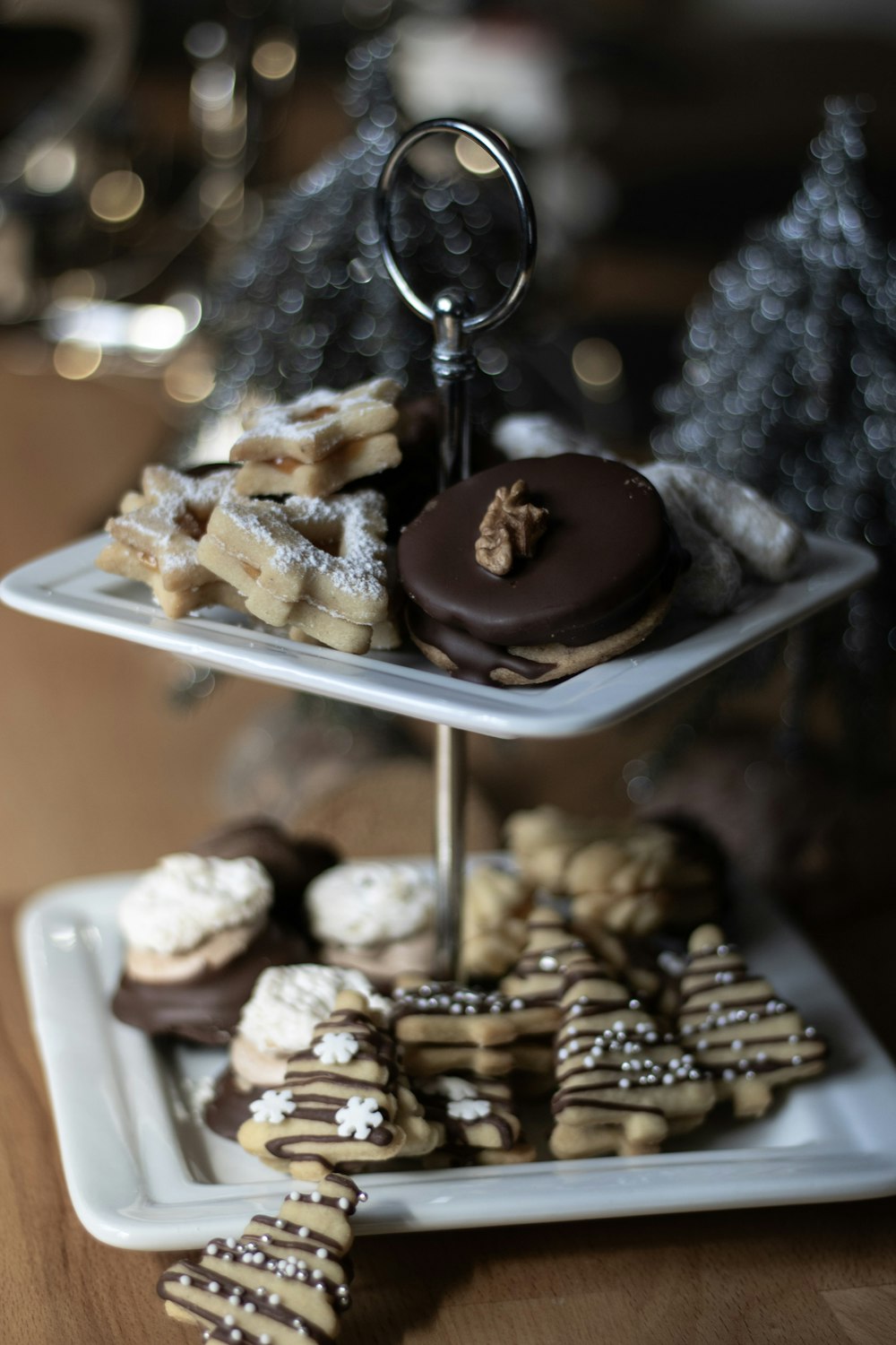 a three tiered tray of cookies and pastries