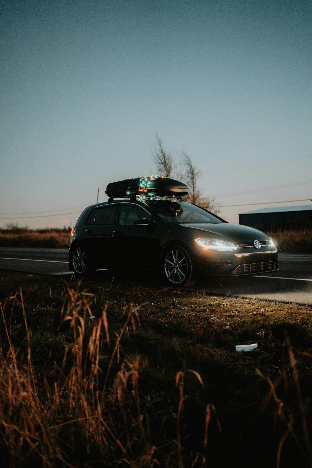 Car with gear mounted to roof rack crossbars, ready for a road trip