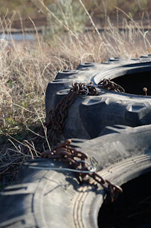 Stabilizer chains and check links attached to a tractor’s three-point hitch, demonstrating secure lateral stability