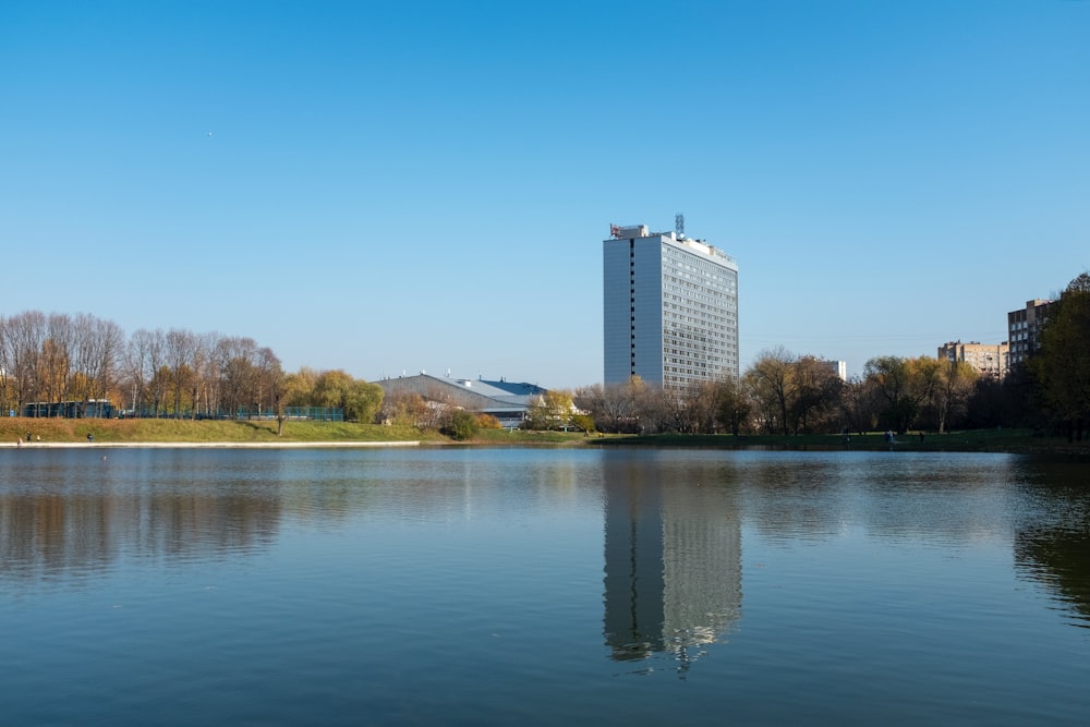 a body of water with a building in the background