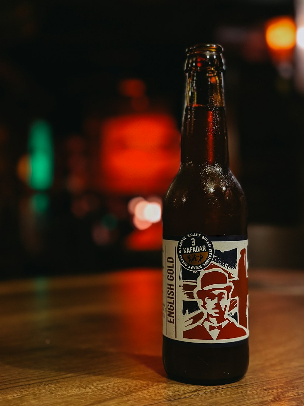 a bottle of beer sitting on top of a wooden table