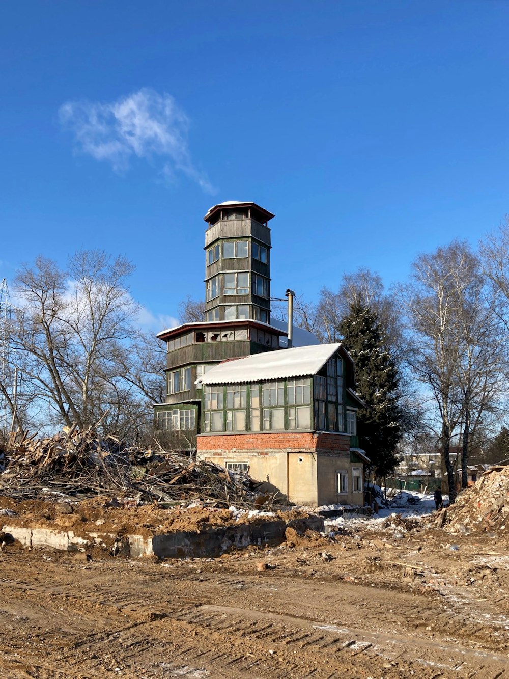 a tall building sitting on top of a dirt field