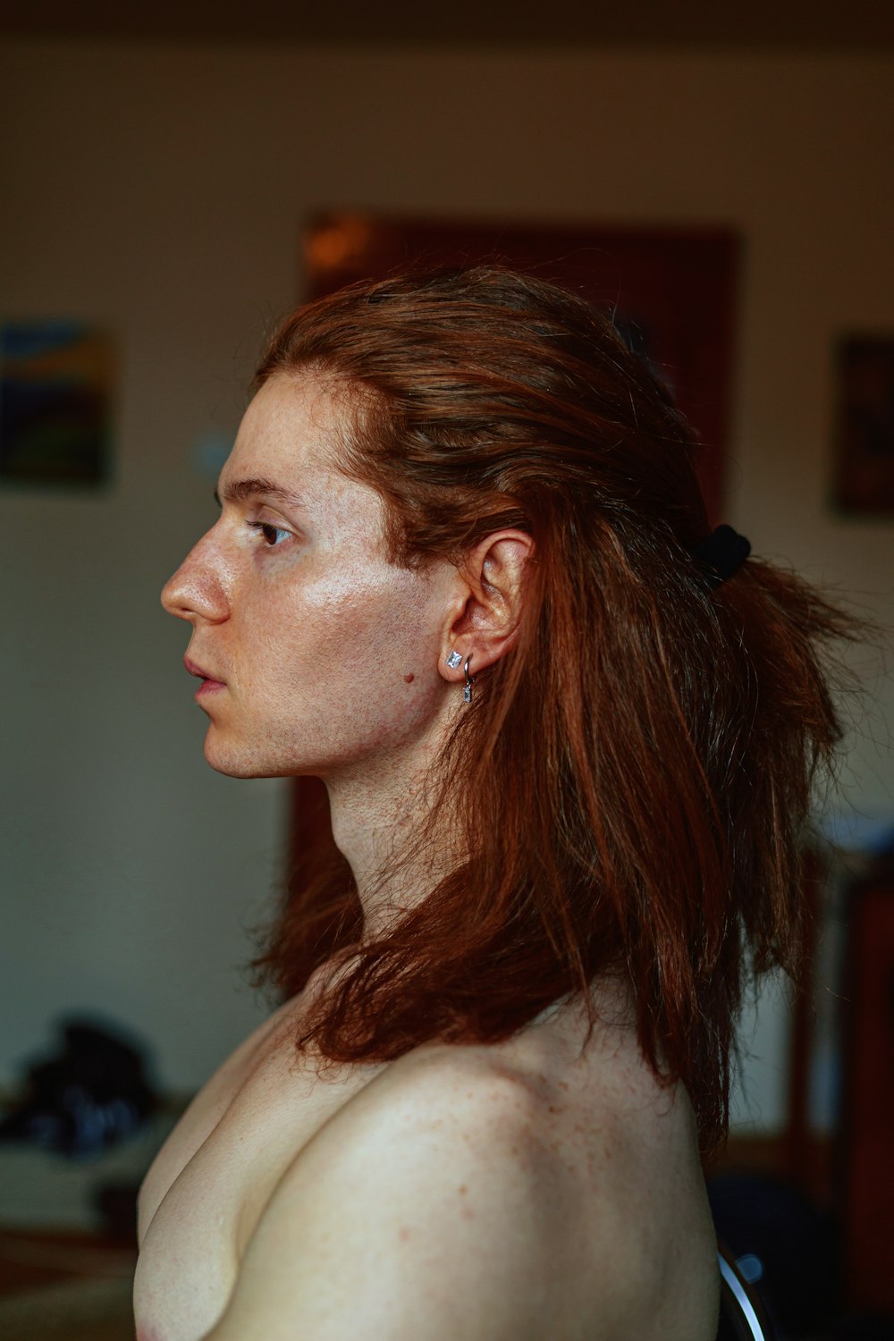 a woman with freckled hair is looking off into the distance