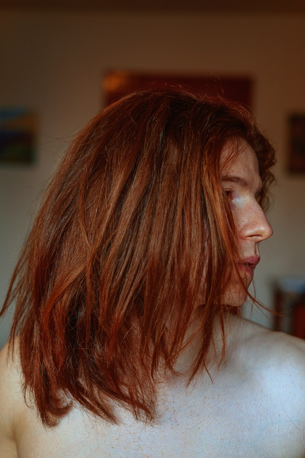 a woman with red hair and no shirt on