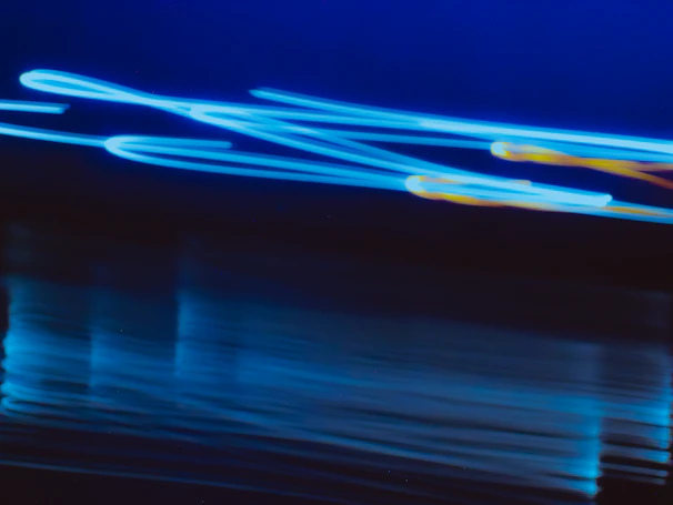 Bright blue and yellow abstract light streaks representing electric energy flow.