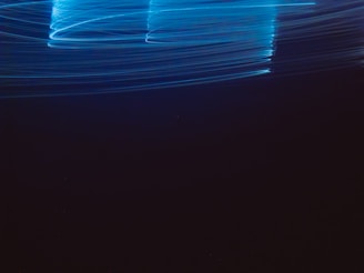 Dynamic shot of electric blue light trails symbolizing energy flow and innovation in electrical parts.