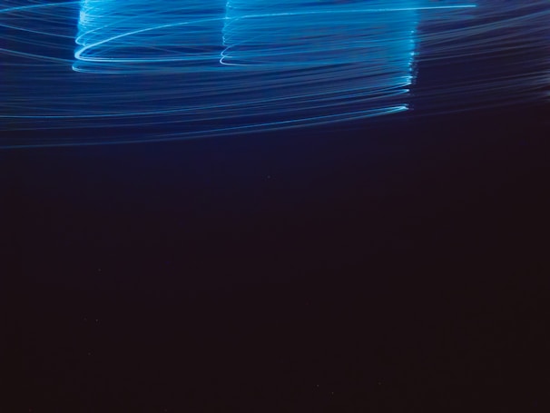 Dynamic shot of electric blue light trails symbolizing energy flow and innovation in electrical parts.