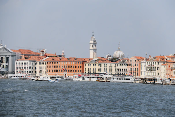 Stresa's elegant waterfront with colorful boats moored gently along the shore.