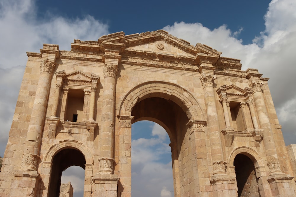 a large stone arch with a sky background