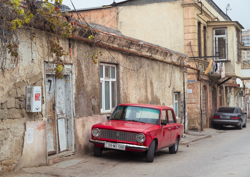 a red car parked on the side of a street