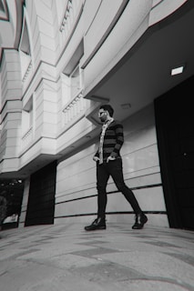 A woman in an oversized unriched sweatshirt walking confidently down a bustling city sidewalk.