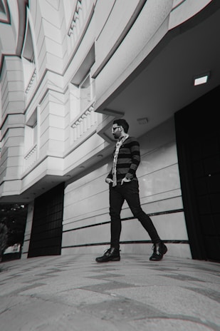 A woman in an oversized unriched sweatshirt walking confidently down a bustling city sidewalk.