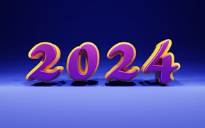 Bold and colorful 3D numbers representing the year 2024 appear in the center of the image against a gradient blue background. The numbers are in a bright purple with a yellow outline, casting shadows on the floor.