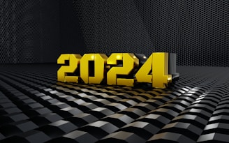 Golden 3D numbers forming '2024' placed on a reflective, textured black surface with a geometric pattern, giving a futuristic and sleek appearance.
