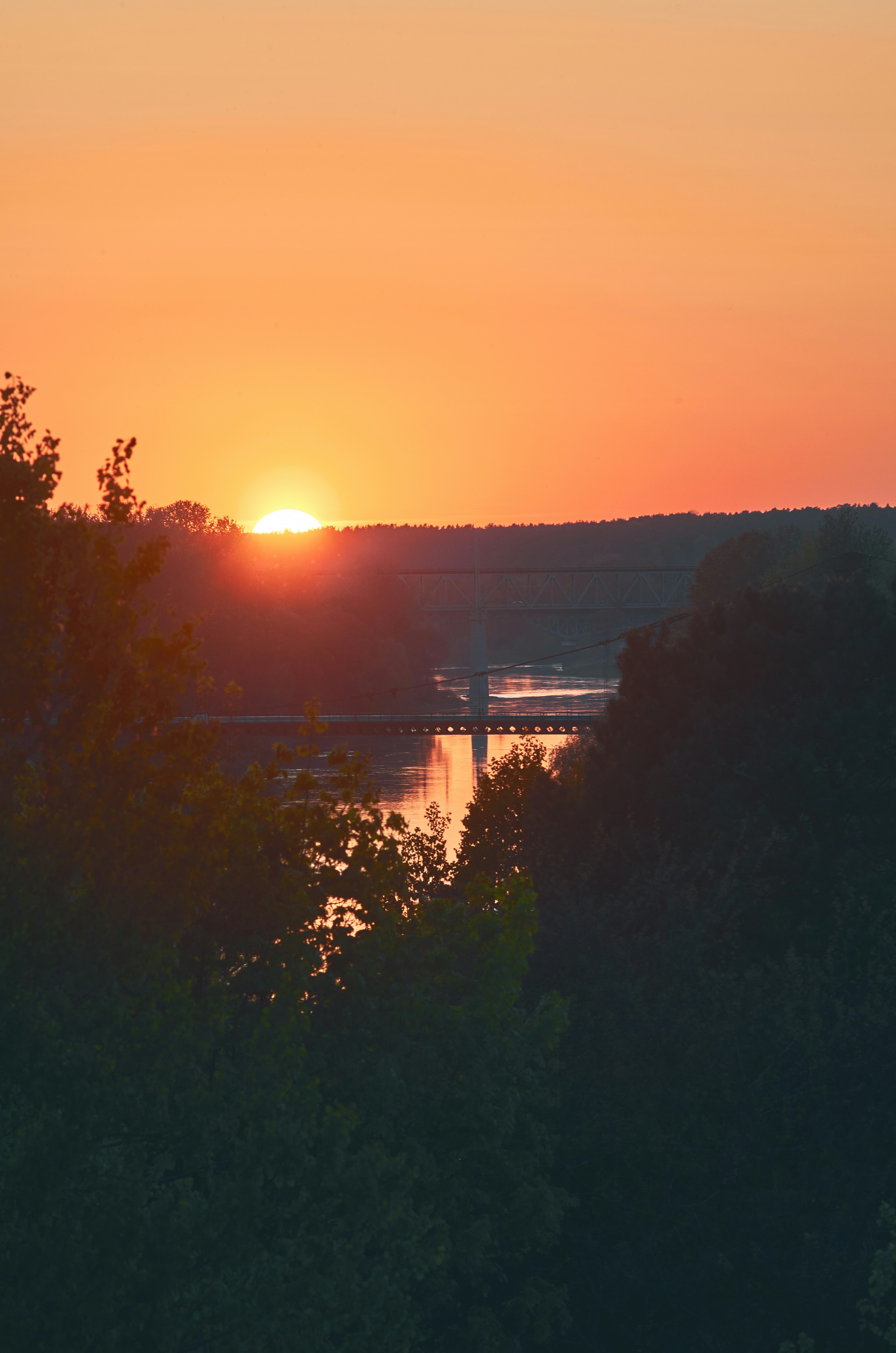 the sun is setting over a body of water