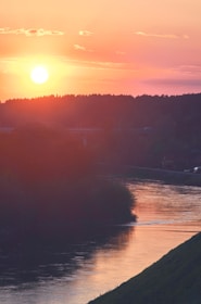 A beautiful sunset over a tranquil river landscape.