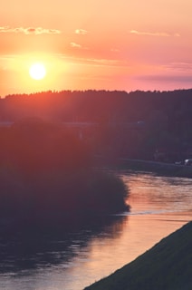 A beautiful sunset over a tranquil river landscape.
